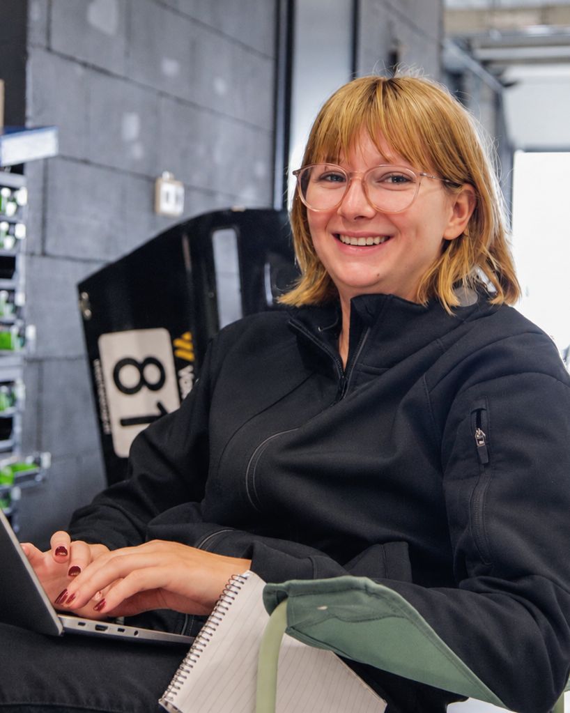 Sia Linnemann working on a laptop in the garage